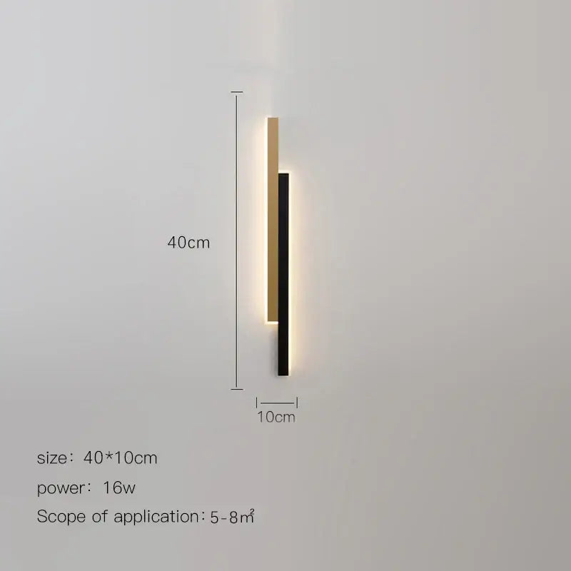 Modern led black wall lamp with two vertical bars in matte black and brushed gold emitting warm gold glow decorbites led black