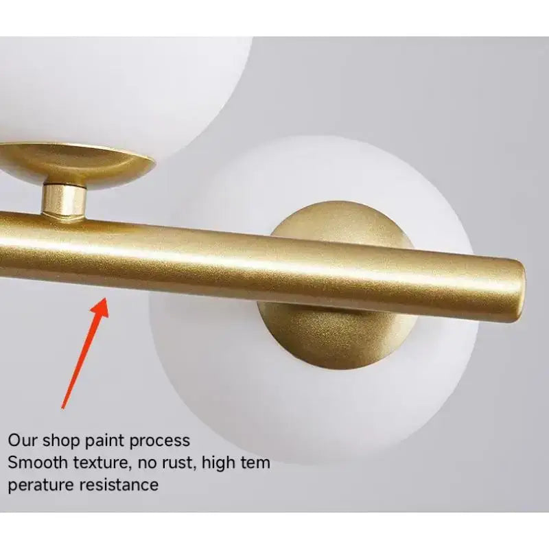 Gold-finished metal bar with matte smooth texture and rounded ends in modern black head ring chandelier by decorbites