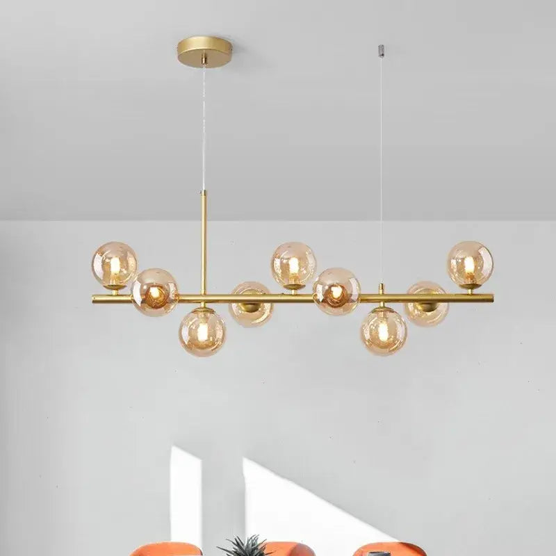 Gold-toned decorbites 9-light modern chandelier with amber glass globe bulbs and central head ring chandelier design