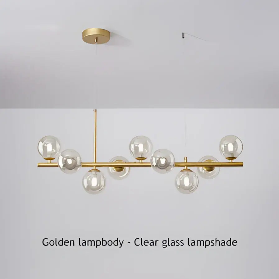 Golden pendant light with clear glass globe shades on a modern chandelier by decorbites featuring a head ring design