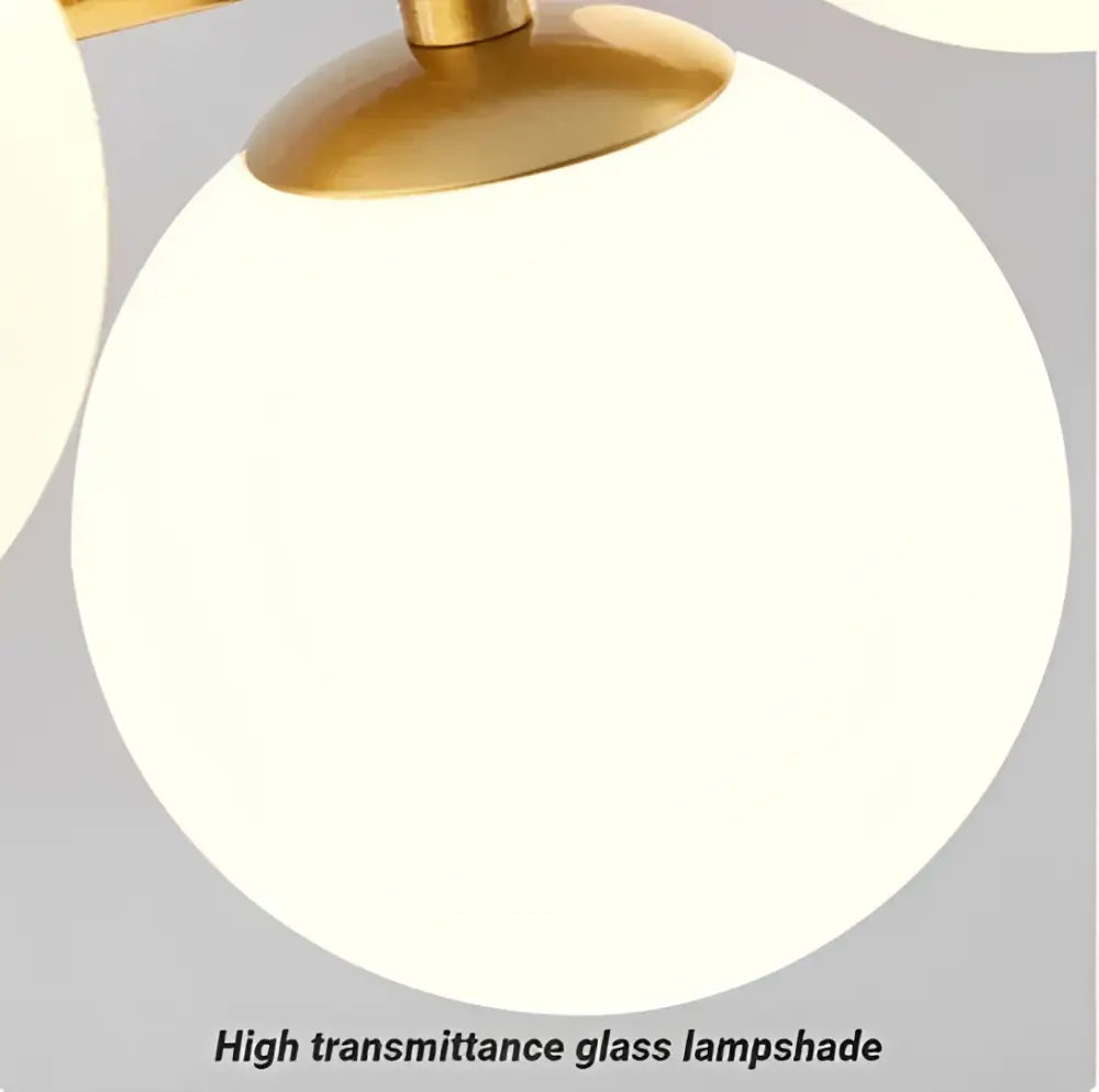 A sleek opal-white glass lampshade with polished brass fixture on a modern chandelier head ring design