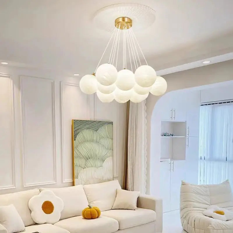 A modern cloud-shaped luxury led pendant lamp with milk white glass balls and gold fixture for living room lighting