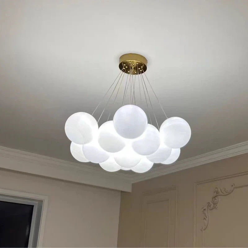 A modern cloud-shaped luxury led chandelier with milk white glass balls and gold ceiling mount for living room lighting decor