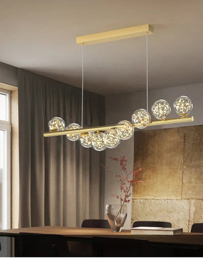 Gold-toned modern led ceiling chandelier with sleek horizontal bar and clear glass globe bulbs for dining room decor