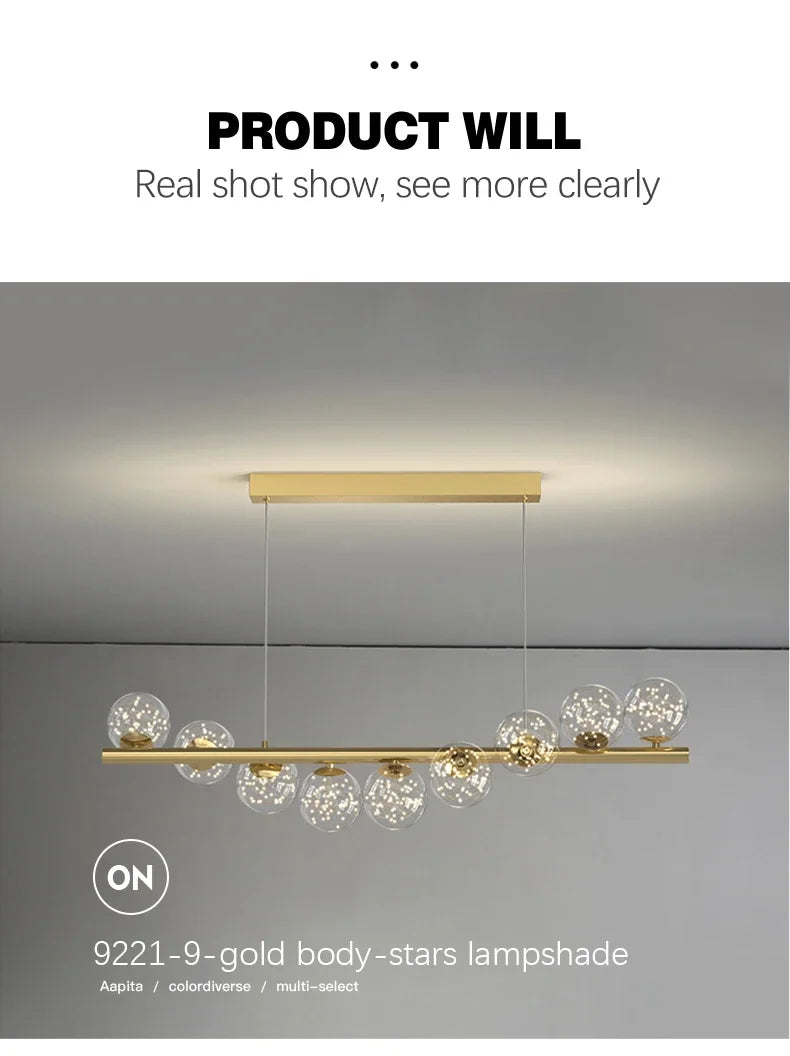Gold-toned modern LED ceiling chandelier with clear glass globe shades on a sleek bar for dining room or kitchen decor