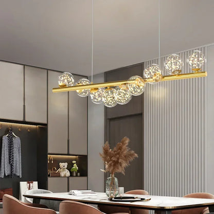 Gold-toned modern led ceiling chandelier with clear glass globe bulbs on a sleek horizontal bar for dining room decor
