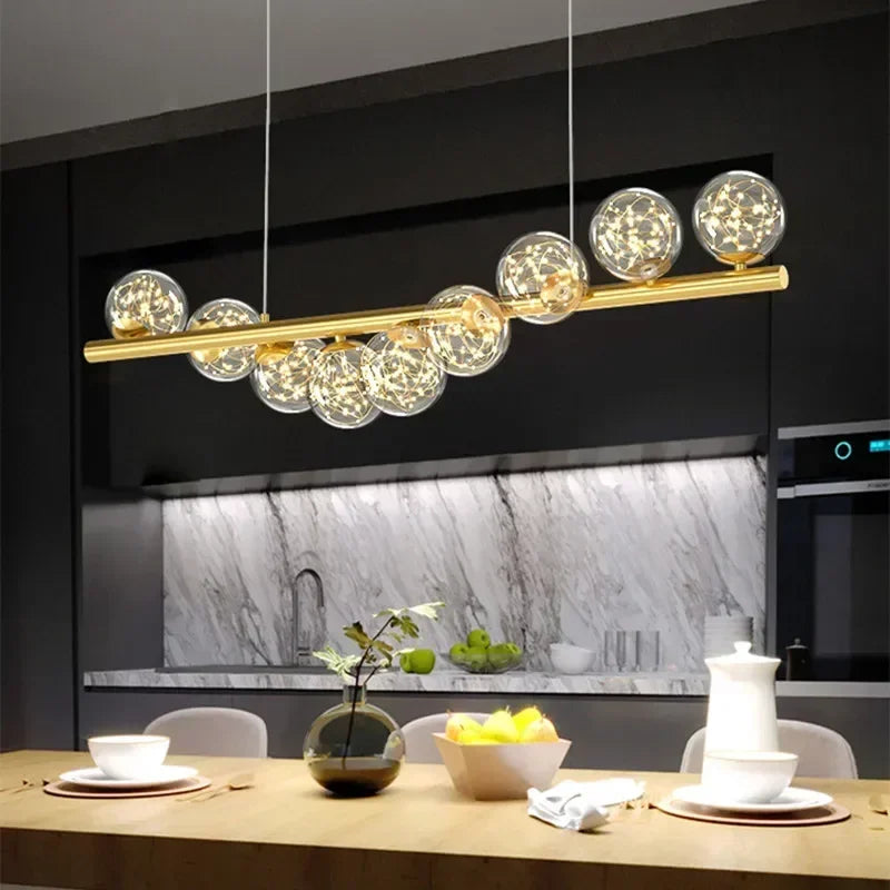 Gold-toned modern led pendant light with clear glass spheres and warm leds for dining room kitchen decor