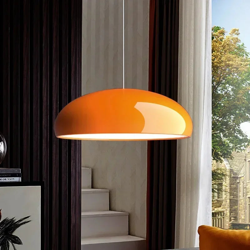 Vibrant orange dome-shaped pendant light with glossy finish made of round aluminum for modern room decor
