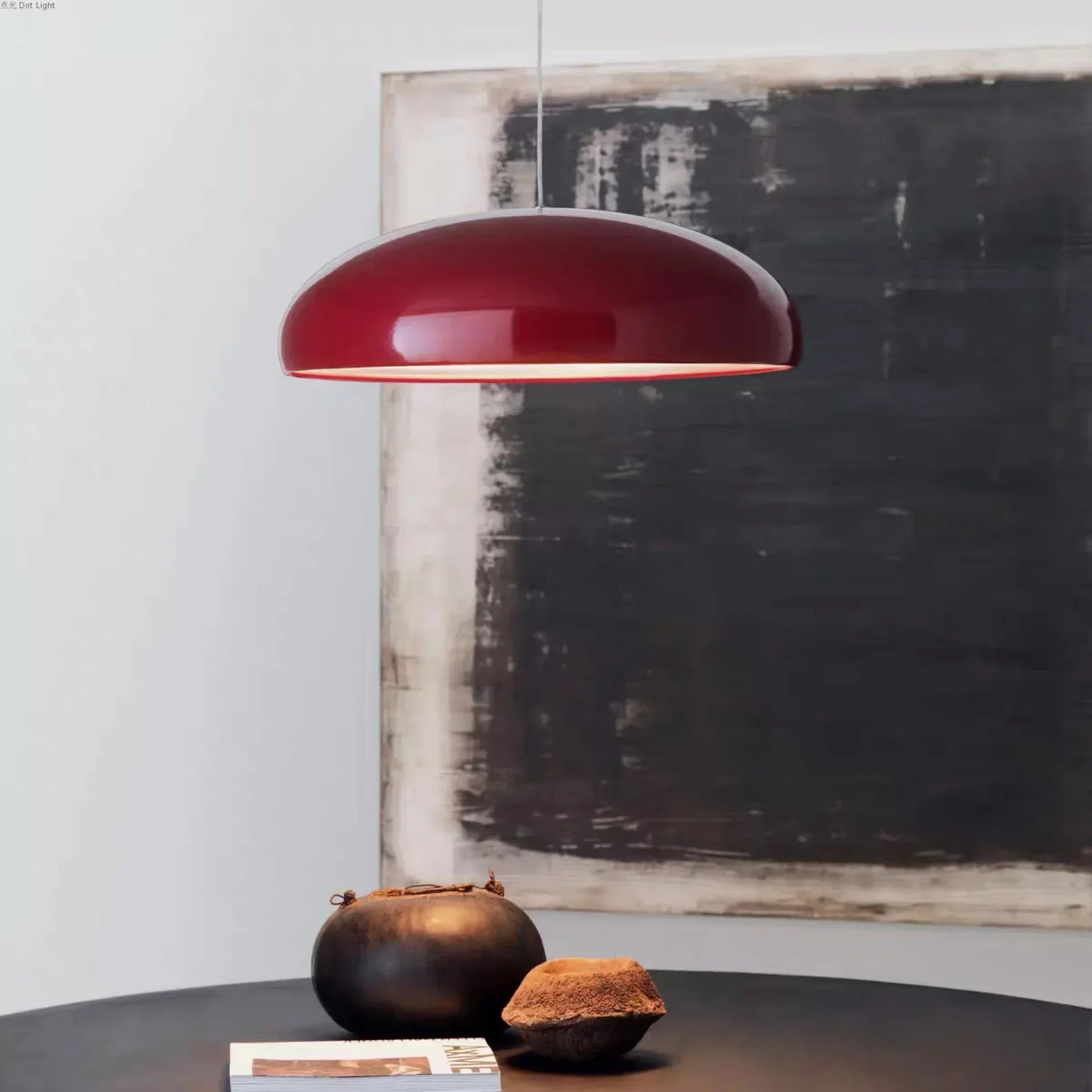 A sleek glossy red pendant light with a smooth dome-shaped round aluminum lampshade for modern room decor