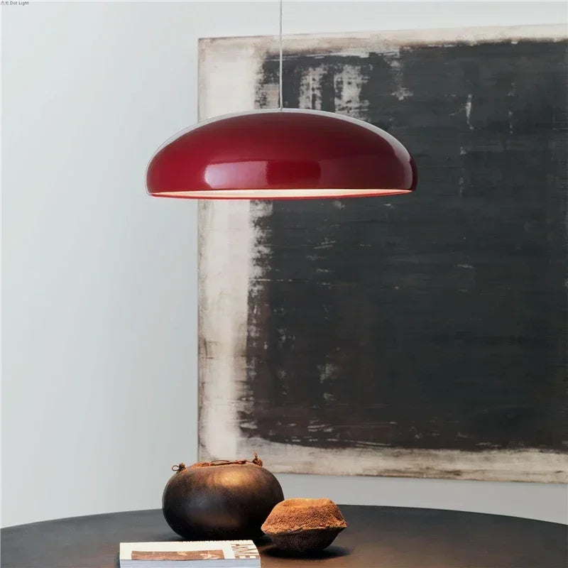 A sleek glossy red pendant light with round aluminum lampshade ideal for modern dining table decor