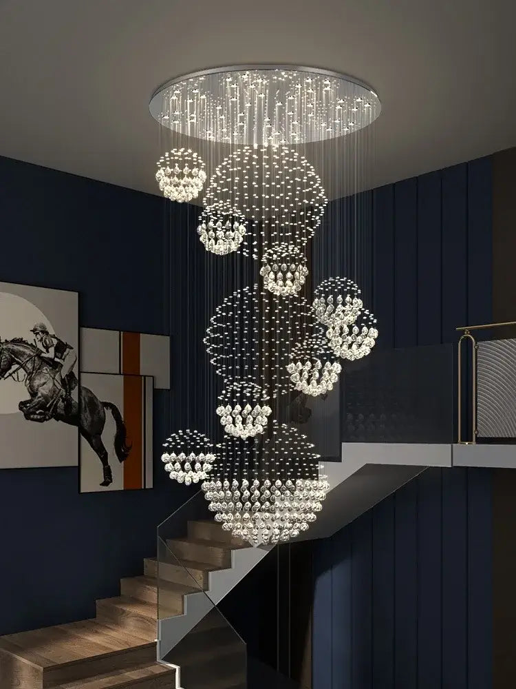 A modern decorbites crystal ball chandelier with cascading crystal spheres and a metallic frame for staircase lighting