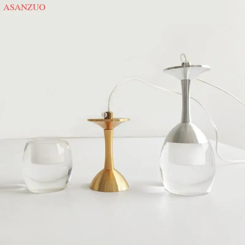 Gold-toned metal candle holder with flared base and slender stem for decorbites led wine pendant lights chandelier