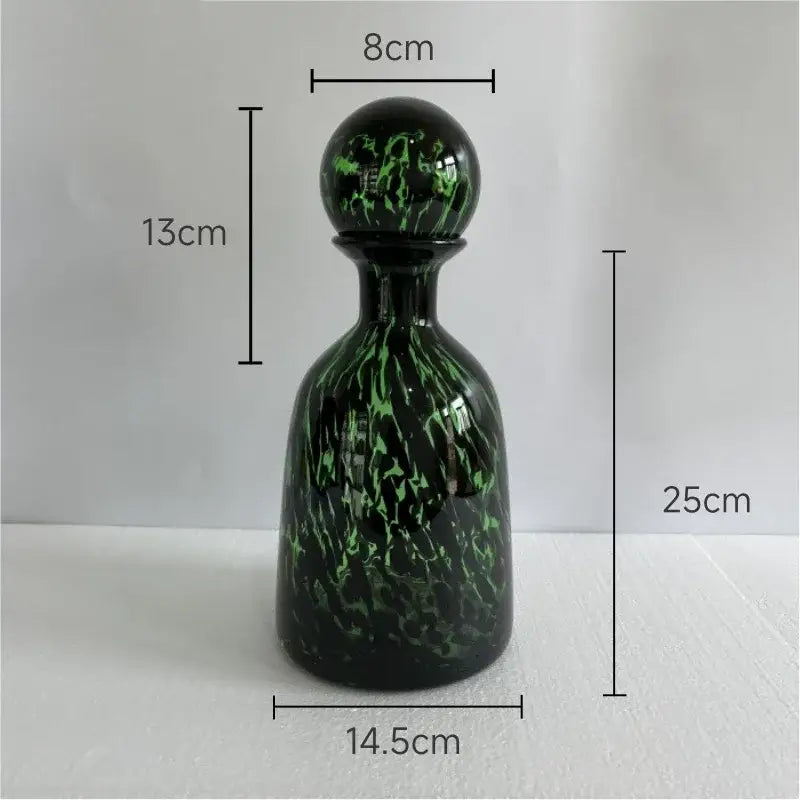 A sleek 25cm tall modern leopard texture glass decanter with glossy black base and green marbled patterns for dining decorbites