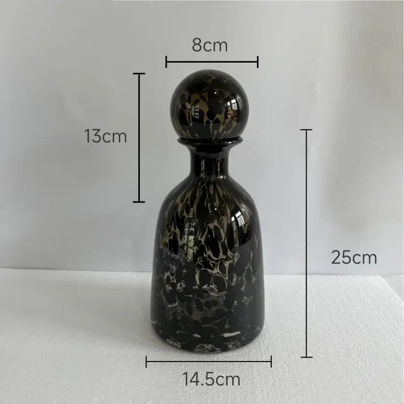 Elegant black glass decanter with glossy marbled finish and spherical stopper featuring decorbites leopard texture design