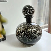 Elegant black glass decanter with swirling white marbled pattern and decorbites leopard texture for dining room decor