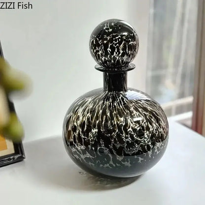 Elegant black glass decanter with swirling white marbled pattern and decorbites leopard texture for dining room decor