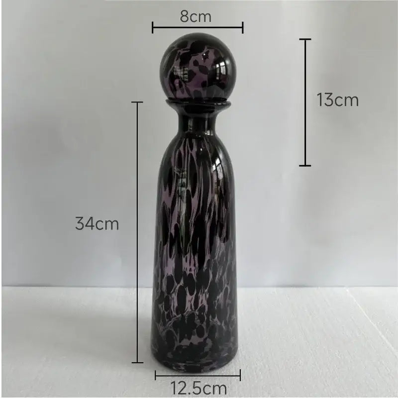 A tall 34cm glass decanter with dark purple black marbled leopard texture and spherical stopper for dining room decorbites leopard texture