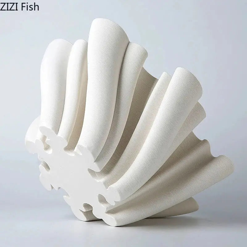 Modern light blue bud shape ceramic vase with white shell-shaped decorbites bud shape ceramic sculpture