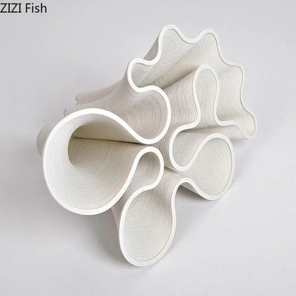 White sculptural ceramic vase with flowing wave like curves and concentric ridges for modern decorbites bud shape decor