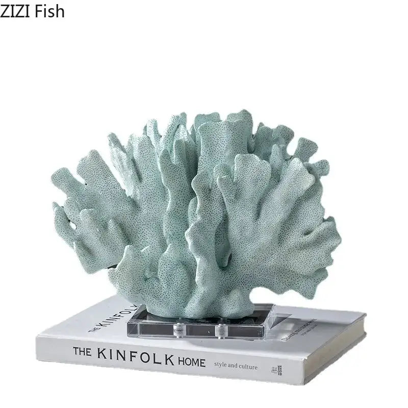 A modern light blue coral resin statue with a textured matte finish on a clear acrylic stand for living room decor