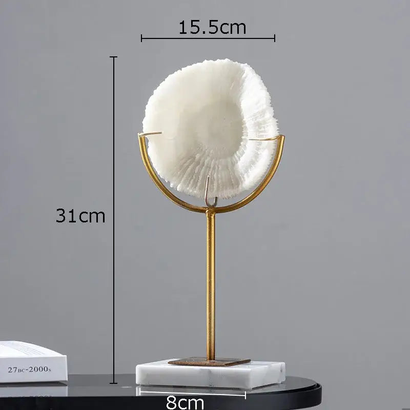 Modern light blue coral resin statue featuring a white textured seashell on a gold metal stand with marble base for decor
