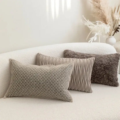 Three beige textured throw pillows with knitted and pleated patterns on decorbites light grey coffee cushion covers