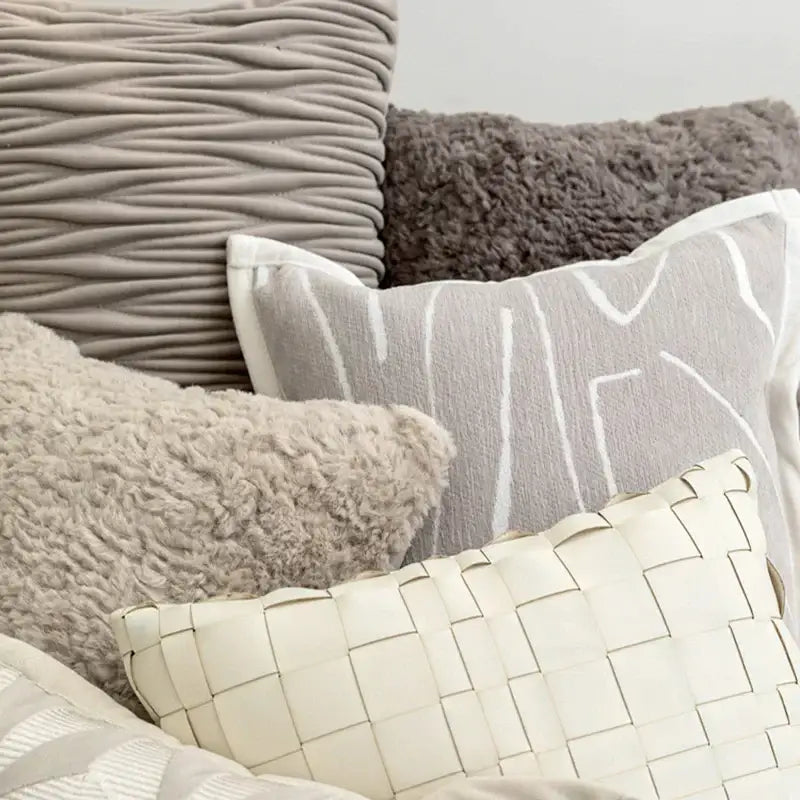 A cream-colored woven leather cushion cover with geometric grid pattern for decorbites light grey coffee decor