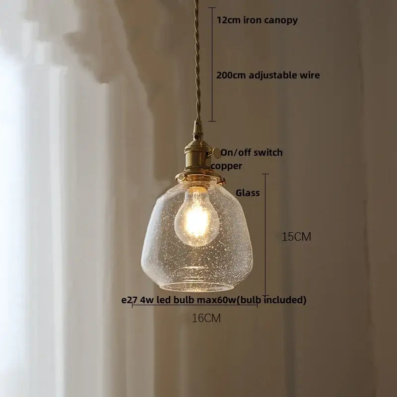 Modern lime and teal blue bubble glass ball pendant light with warm glowing decorbites bubble glass and brass hardware