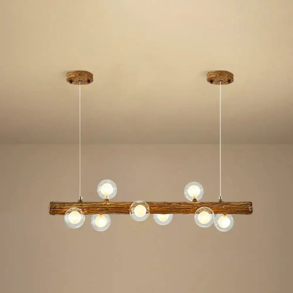 Rustic wooden beam pendant light with six clear glass globe bulbs in a brown modern linear island pendant lamp