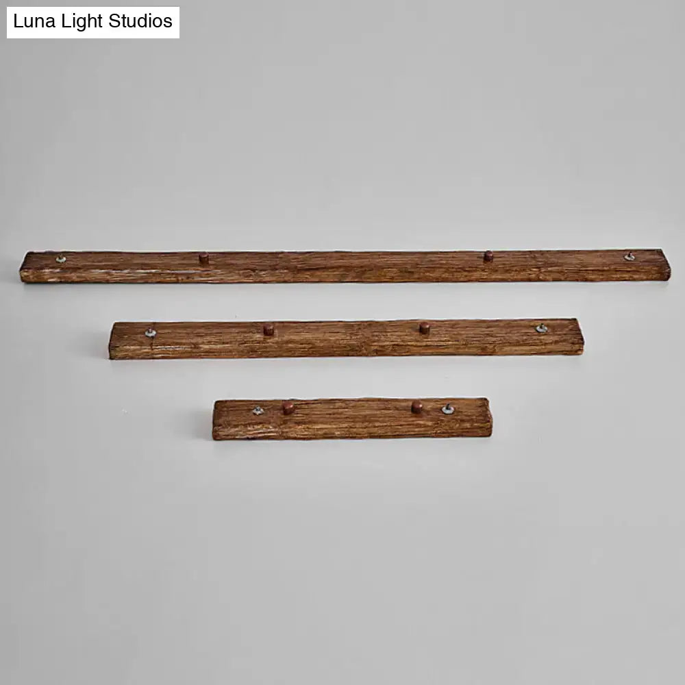 Set of three rustic wooden coat racks with dark brown finish and metal hooks complementing modern linear design