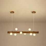 Rustic wooden log pendant light with six frosted glass globe bulbs by DecorBites brown modern linear island pendant lamp