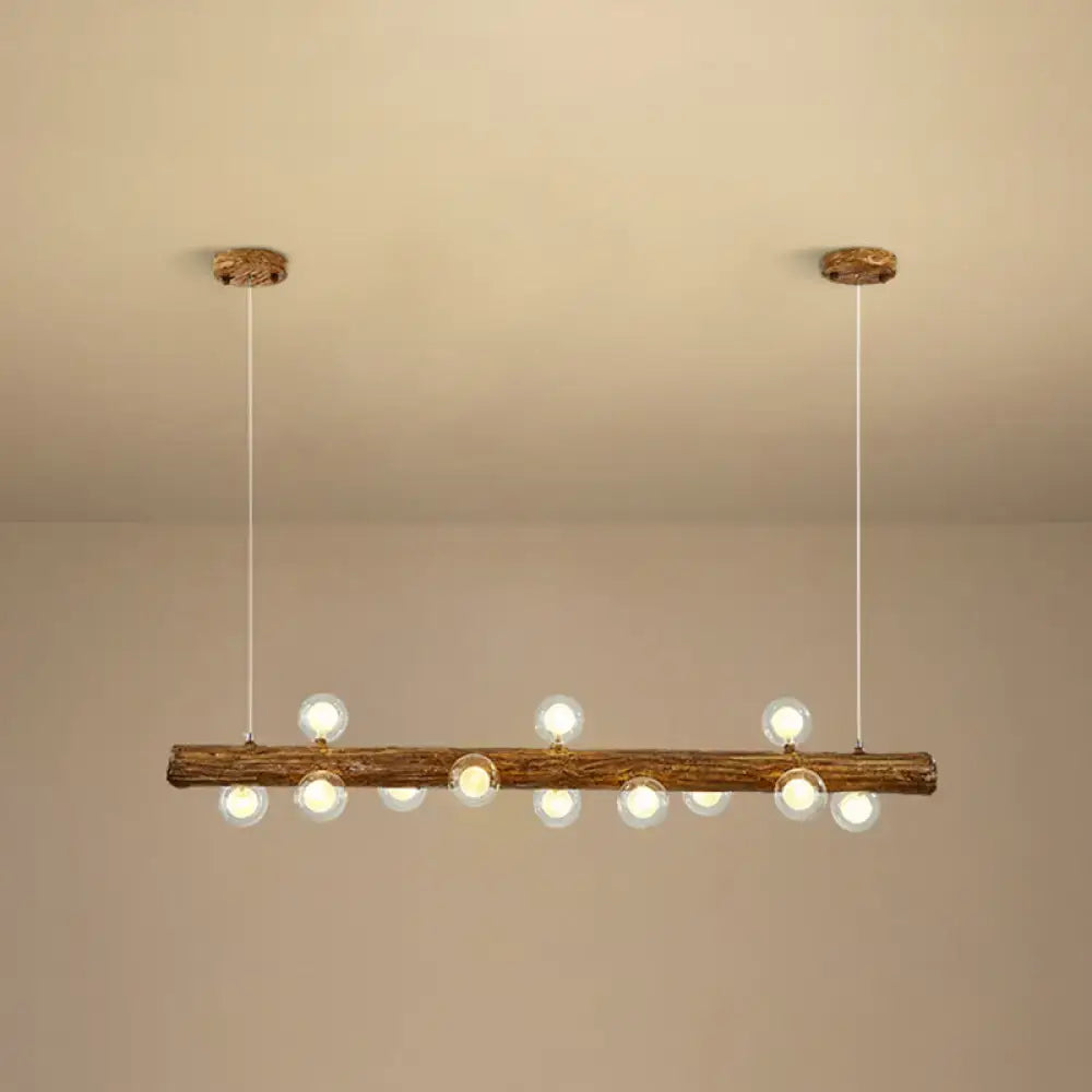 Rustic wooden log pendant light with clear glass globe bulbs for modern linear island use by DecorBites brown metal lamp