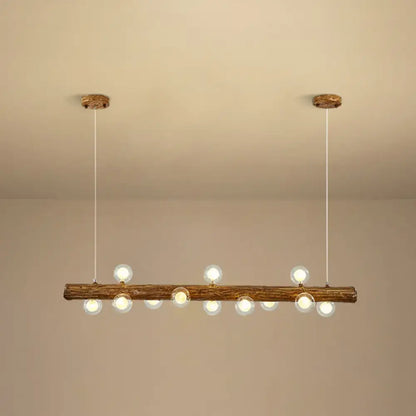 Rustic wooden log pendant light with clear glass globe bulbs for modern linear island use by DecorBites brown metal lamp