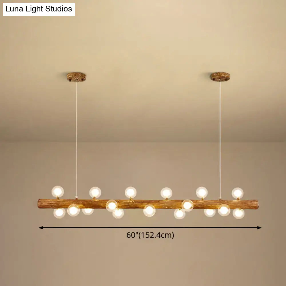Rustic brown wooden log pendant light with multiple spherical bulbs for modern linear island lighting by DecorBites