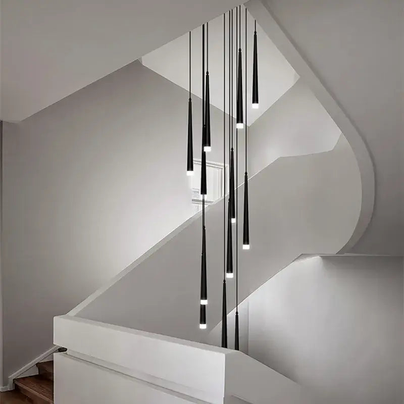 Modern loft black led stair chandelier with black cylindrical pendant lights hanging above staircase decorbites loft black