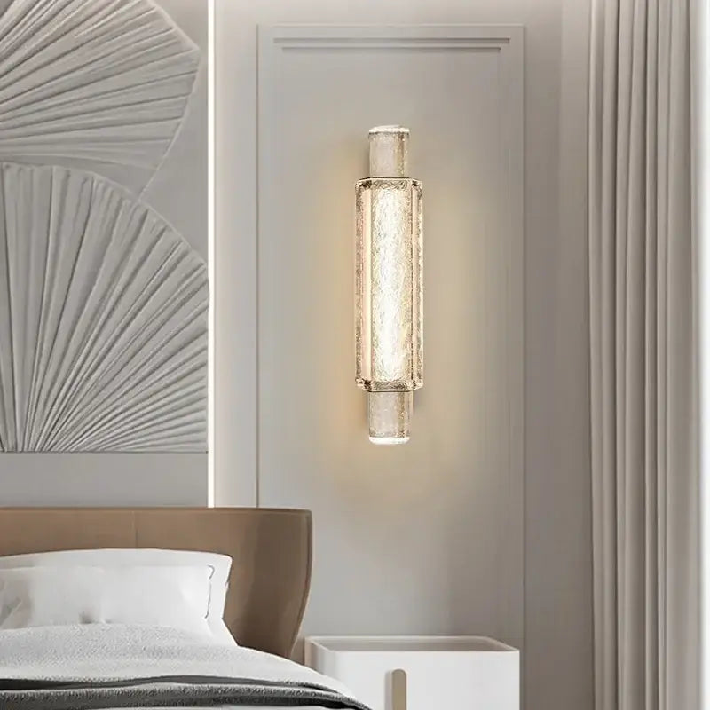 Modern luxe gold crystal glass wall lamp with textured translucent body and metallic accents for elegant bedroom decorbites