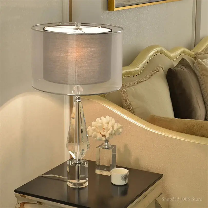 Elegant modern luxe gray crystal table lamp with faceted transparent base and silver-toned shade for bedroom lighting