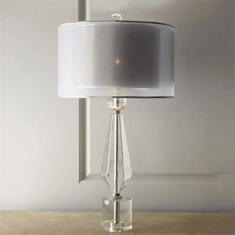Modern luxe gray and crystal table lamp with a faceted transparent base and silver-gray shade for bedroom lighting