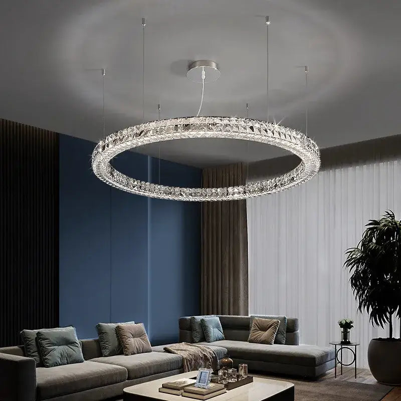 A modern luxury chrome decorbites crystal led chandelier with a silver frame and crystal facets for dining room use