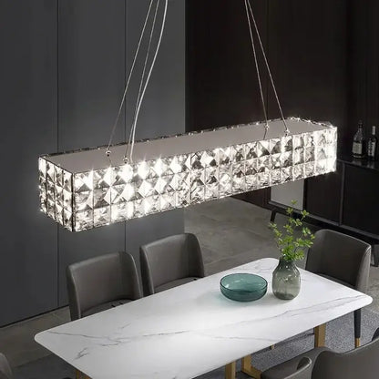 A modern luxury chrome decorbites crystal led chandelier with faceted panels for dining room lighting