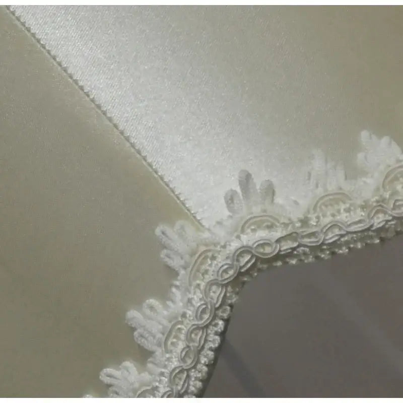 Modern luxury cream fringed cloth lampshade featuring white lace trim with floral patterns and soft satin backing decorbites fringed cloth