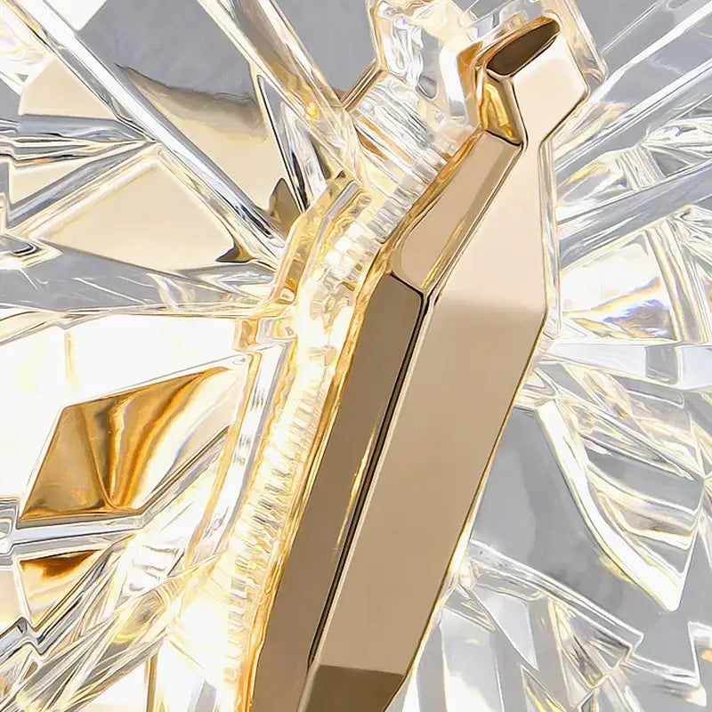 A sleek gold-tone modern luxury crystal butterfly wall lamp with polished facets for elegant bedroom decorbites decor
