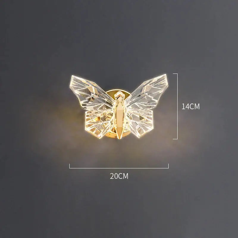 A modern luxury wall lamp with faceted crystal butterfly wings and a gold-toned body for bedroom decorbites butterfly wall decor