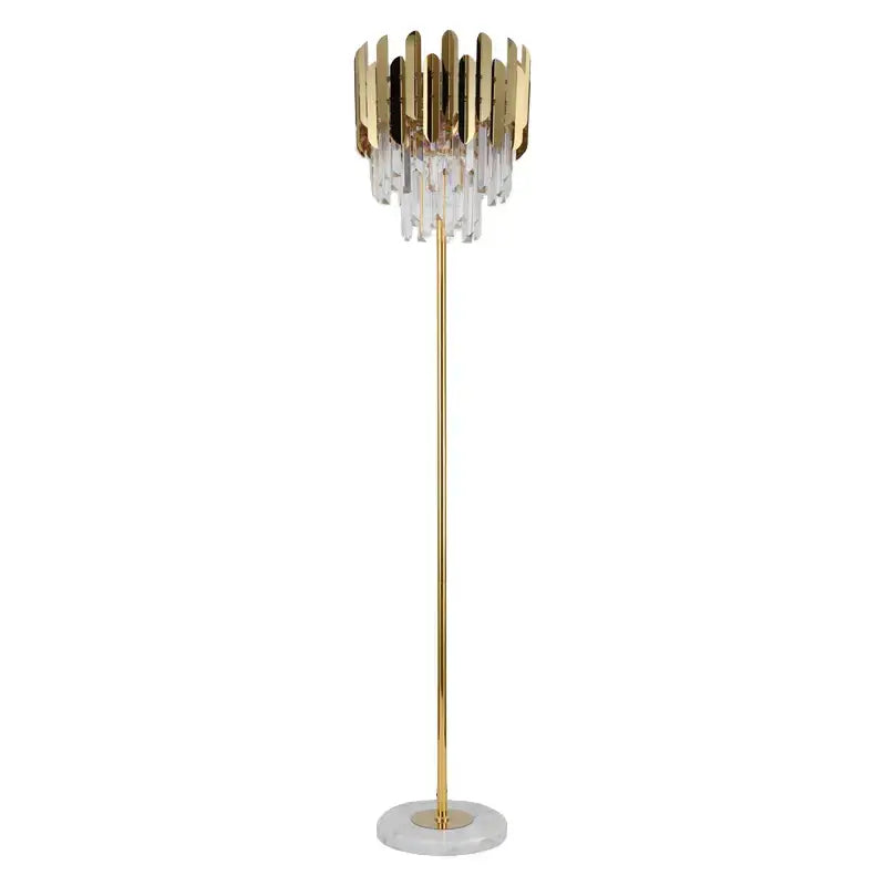 Elegant crystal gold floor lamp with vertical metallic plates and clear crystal droplets on a white marble base