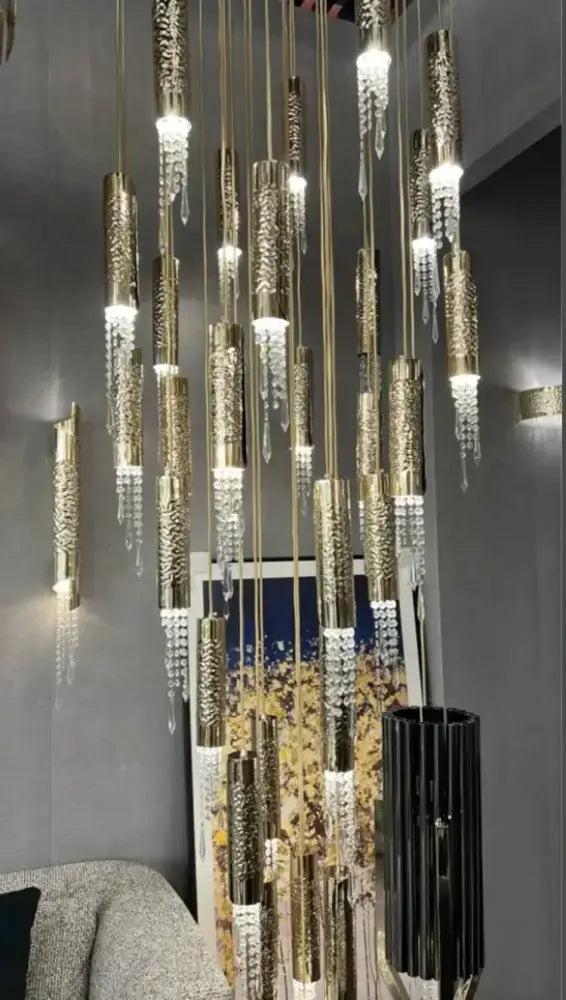 A modern luxury crystal led staircase chandelier with gold-toned etched fixtures and crystal droplets for living room decorbites crystal led