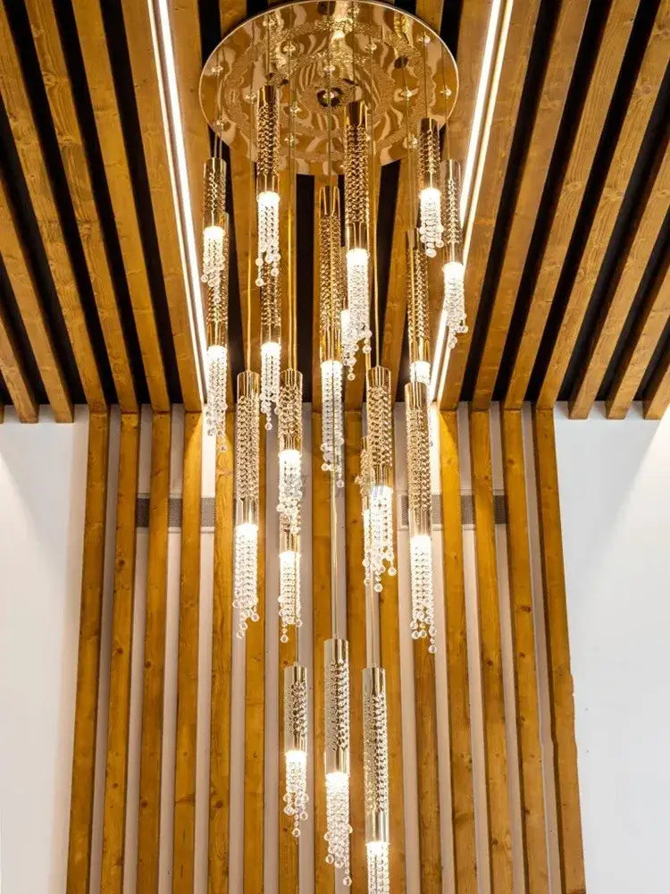 A golden ornate decorbites crystal led chandelier with cascading crystals and glass elements for staircase hall decor