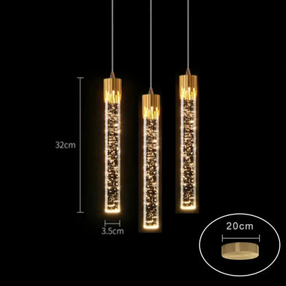 Three elegant gold-toned cylindrical modern luxury crystal pendant lamps with sparkling LED bulbs for home decor