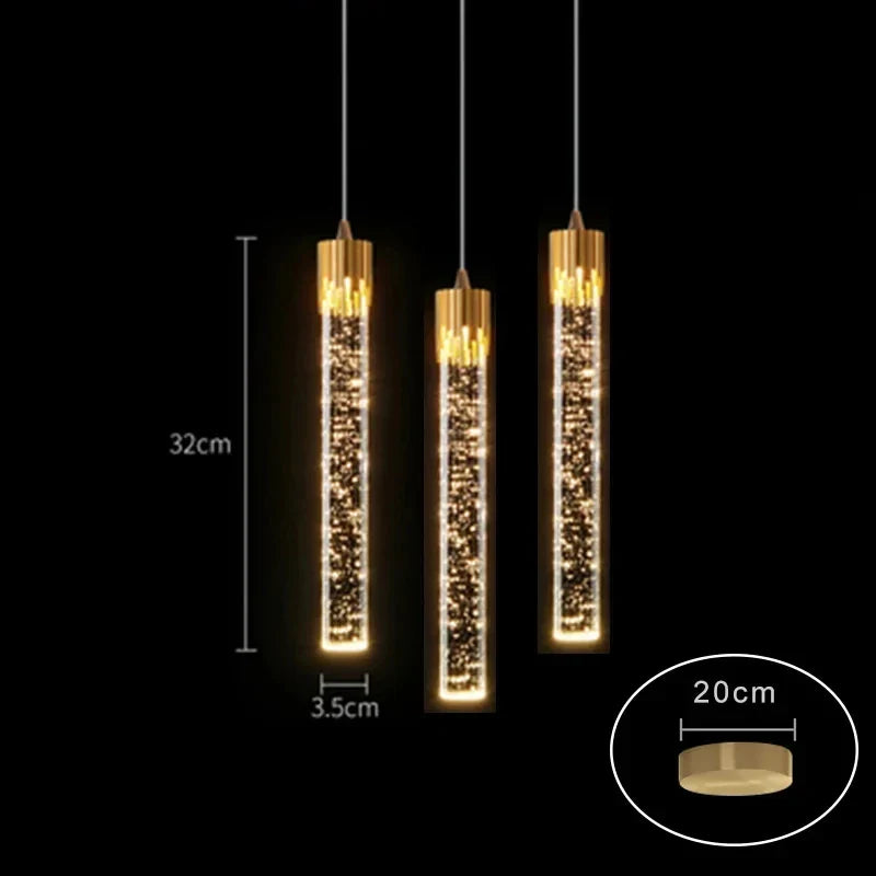 Three elegant gold-toned cylindrical modern luxury crystal pendant lamps with sparkling LED bulbs for home decor