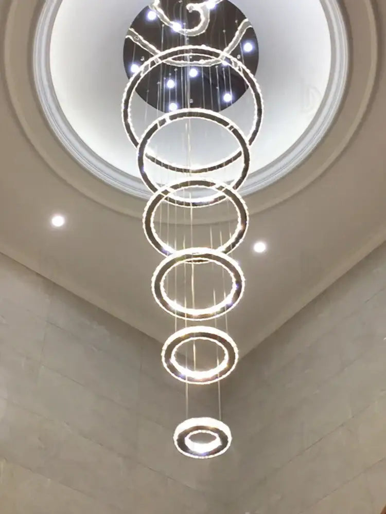 A modern luxury crystal rings chandelier with polished chrome concentric rings and embedded led lights by decorbites crystal
