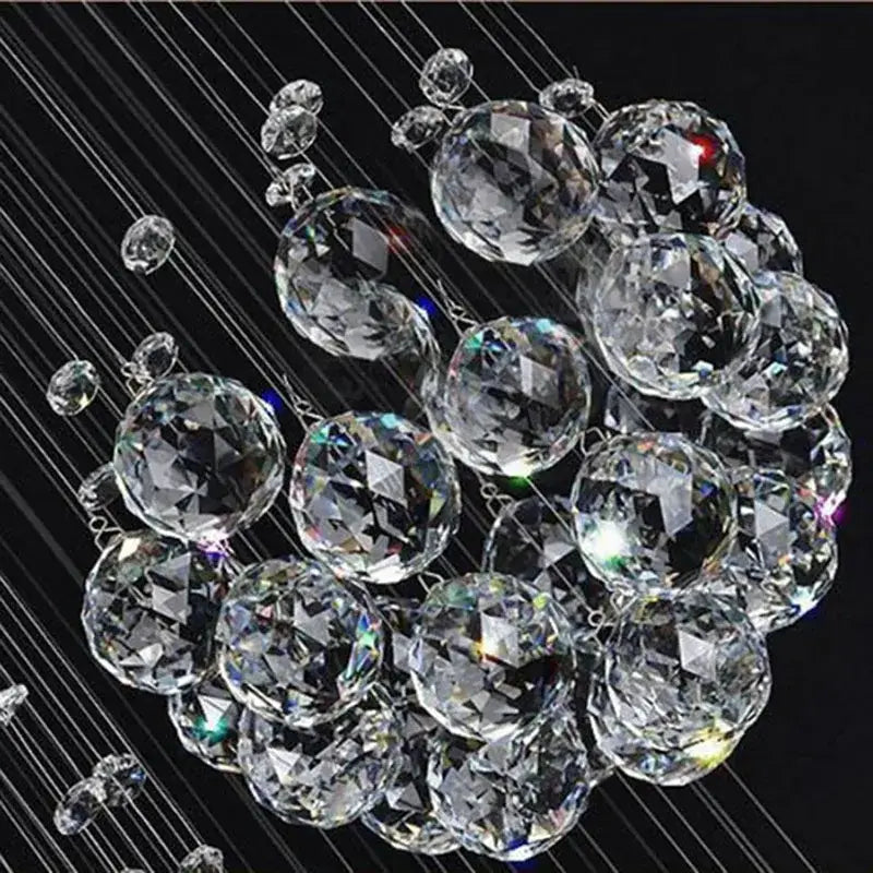 A cluster of clear faceted crystal spheres in a modern luxury decorbites crystal staircase chandelier pendant light
